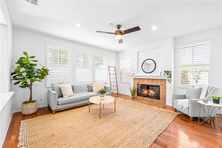 Designed for seamless everyday living and entertaining, the expansive great room flows effortlessly into the kitchen, dining, and breakfast areas with rich wood floors, recessed lighting, a cozy fireplace, and wall-to-wall windows.