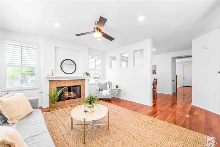 Designed for seamless everyday living and entertaining, the expansive great room flows effortlessly into the kitchen, dining, and breakfast areas with rich wood floors, recessed lighting, a cozy fireplace, and wall-to-wall windows.