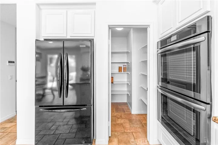 Spacious and beautifully connected to the living areas, the kitchen features a generous breakfast nook, center island with seating and storage, abundant cabinetry, walk -in pantry, and sunlit backyard views.