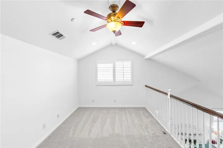 The expansive primary suite offers soaring ceilings, dramatic wall-to-wall windows, a unique upper loft retreat, spa-inspired bath with soaking tub, dual vanities, a linen closet, and a walk-in closet.