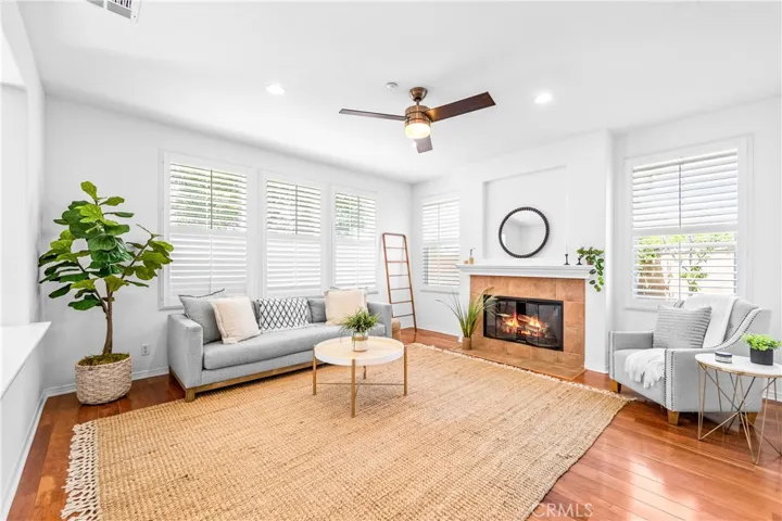 Designed for seamless everyday living and entertaining, the expansive great room flows effortlessly into the kitchen, dining, and breakfast areas with rich wood floors, recessed lighting, a cozy fireplace, and wall-to-wall windows.