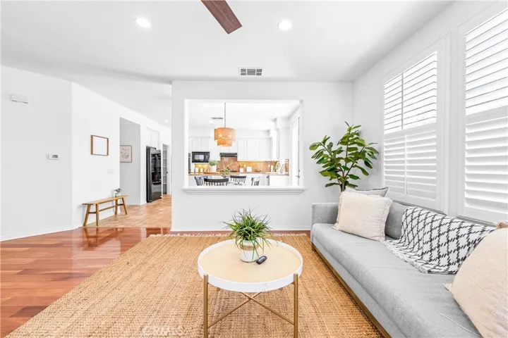 Designed for seamless everyday living and entertaining, the expansive great room flows effortlessly into the kitchen, dining, and breakfast areas with rich wood floors, recessed lighting, a cozy fireplace, and wall-to-wall windows.