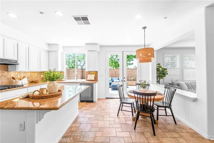 Spacious and beautifully connected to the living areas, the kitchen features a generous breakfast nook, center island with seating and storage, abundant cabinetry, walk -in pantry, and sunlit backyard views.