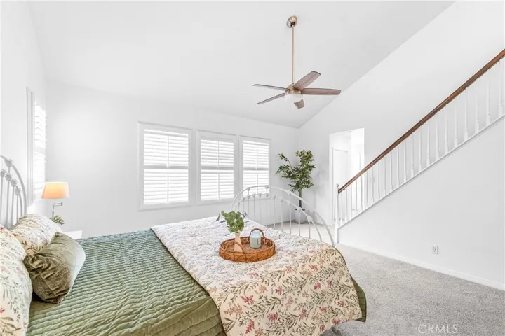 The expansive primary suite offers soaring ceilings, dramatic wall-to-wall windows, a unique upper loft retreat, spa-inspired bath with soaking tub, dual vanities, a linen closet, and a walk-in closet.