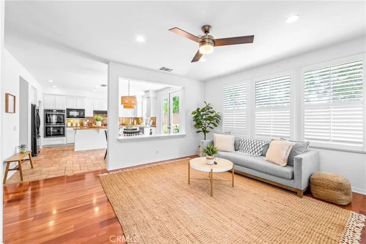 Designed for seamless everyday living and entertaining, the expansive great room flows effortlessly into the kitchen, dining, and breakfast areas with rich wood floors, recessed lighting, a cozy fireplace, and wall-to-wall windows.