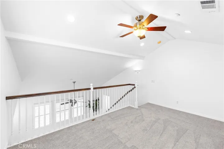 The expansive primary suite offers soaring ceilings, dramatic wall-to-wall windows, a unique upper loft retreat, spa-inspired bath with soaking tub, dual vanities, a linen closet, and a walk-in closet.