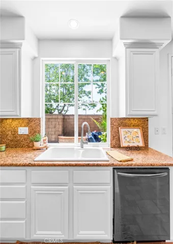 Spacious and beautifully connected to the living areas, the kitchen features a generous breakfast nook, center island with seating and storage, abundant cabinetry, walk -in pantry, and sunlit backyard views.