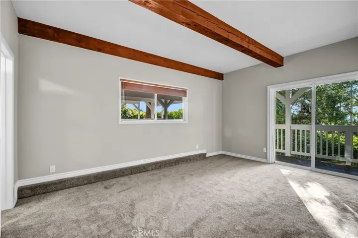 downstairs bedroom 4 with slider to lower deck, yard, and spa