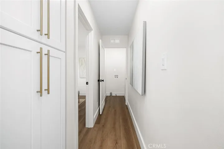 Linen closet and view to indoor laundry