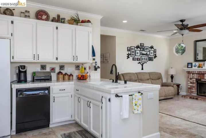 Kitchen island featuring a double-basin sink with a matte black faucet