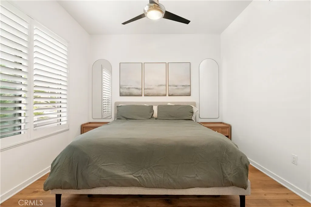 Comfortable secondary bedroom with modern ceiling fan and plenty of natural light.