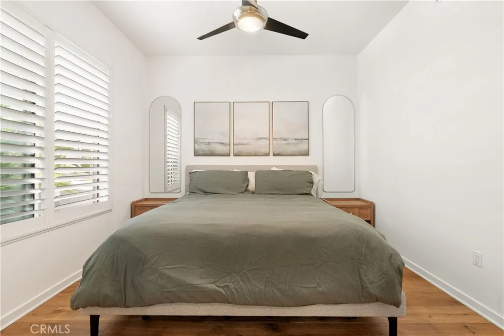 Comfortable secondary bedroom with modern ceiling fan and plenty of natural light.