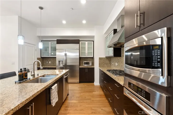 Chef inspired kitchen featuring stainless steel appliances, oversized island, and abundant storage.