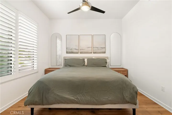 Comfortable secondary bedroom with modern ceiling fan and plenty of natural light.