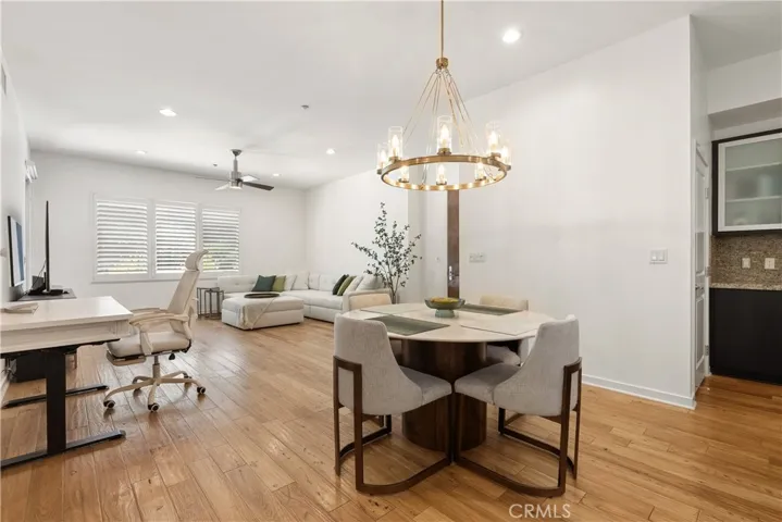 Light filled dining area with stylish lighting and an open flow throughout the main living spaces.