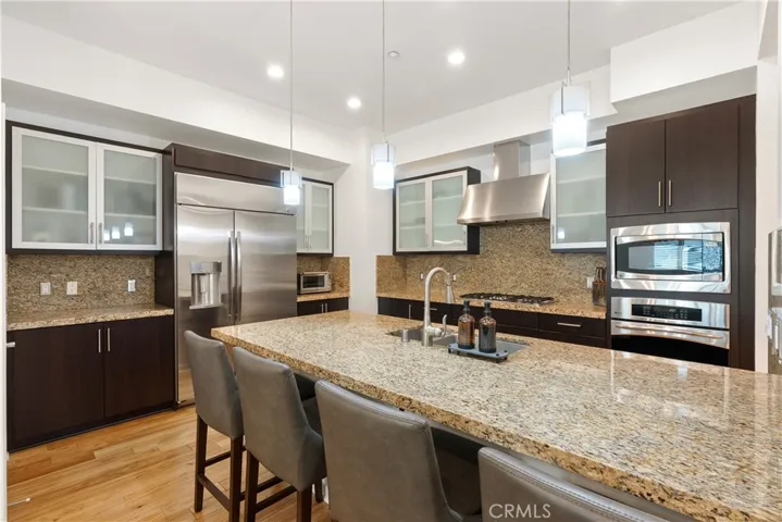 Beautifully updated kitchen with rich cabinetry, stone countertops, and generous prep space.