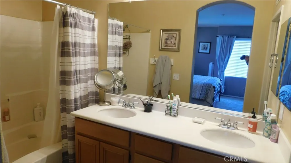 Primary bath has dual vanity - tub and shower.