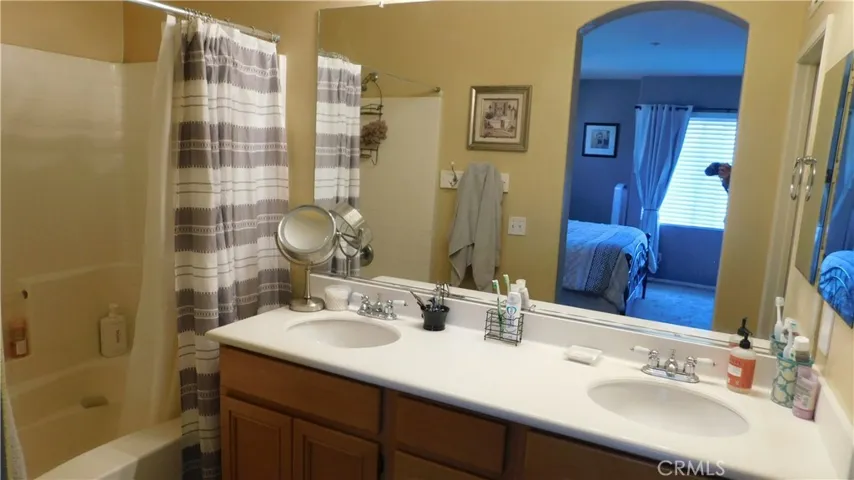Primary bath has dual vanity - tub and shower.