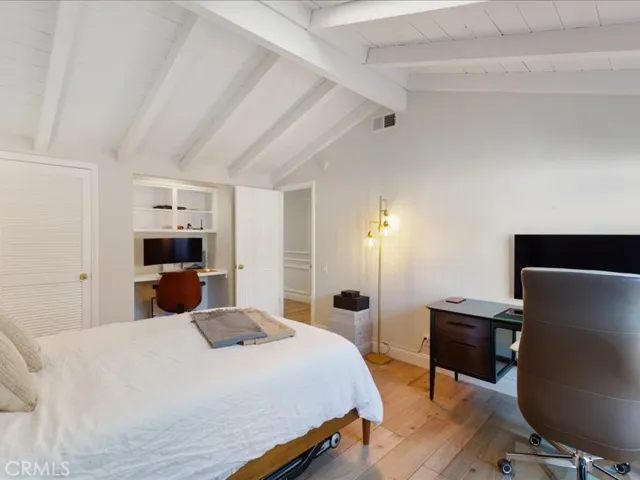 Skylighted secondary bedroom with built-in desk area