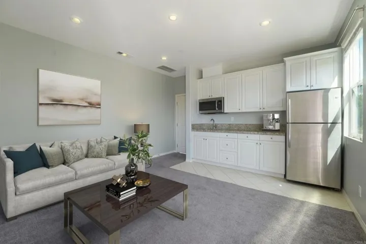 Virtually staged photo to visualize the In-Law suite Family Room and kitchenette