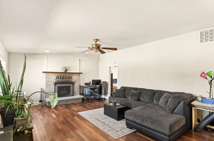 Main home living room with wood-burning fire place