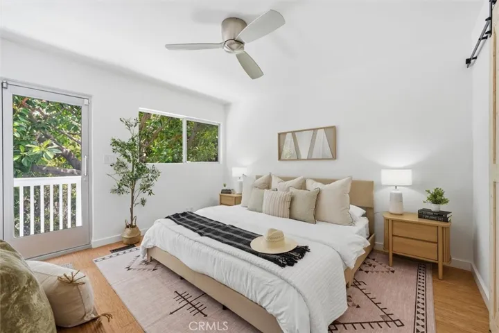 Primary bedroom with walk in closet, attached bathroom & balcony.