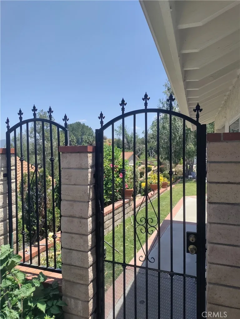 Front side gate.
 Wrought iron fence recently painted