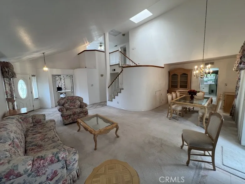  Spacious Living room and dinning room. Wonderful vaulted ceiling with skylight and whole house fan.