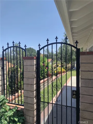 Front side gate.
 Wrought iron fence recently painted