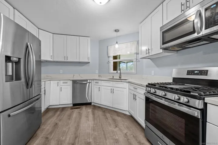 Beautifully Remodeled Kitchen with Stainless Appliances and Quartz Counters
