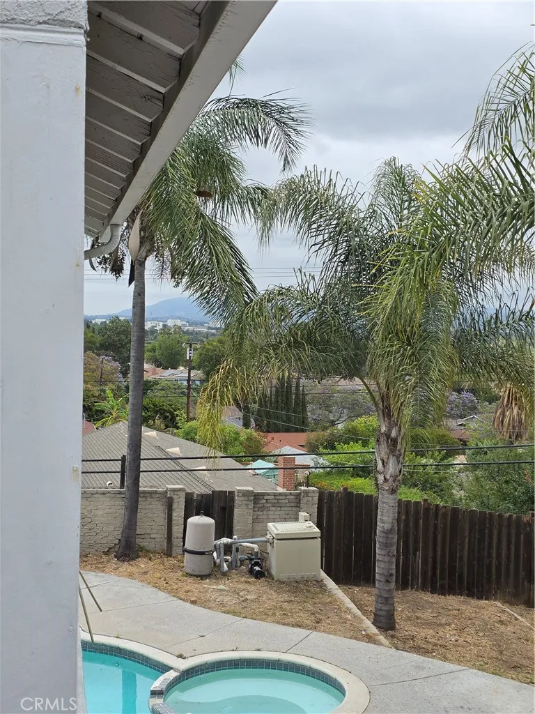 VIEWS FROM BALCONY TOWARDS MOUNTAINS AND CITY BELOW