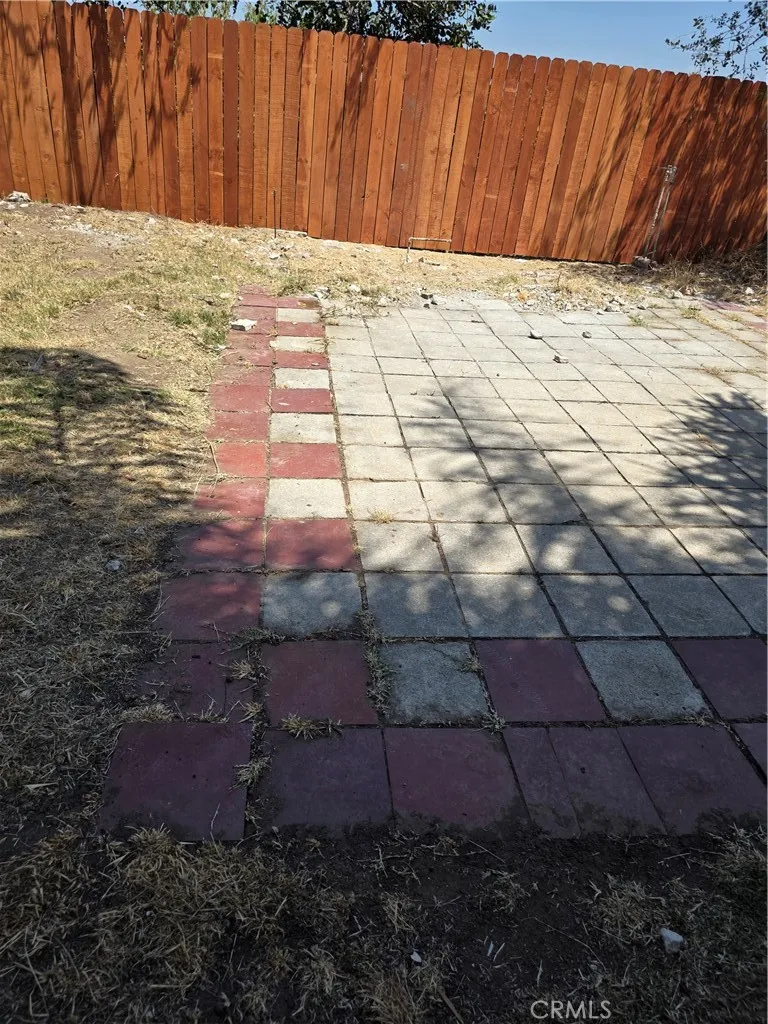 PATIO AREA ABOVE POOL IN BACK YARD