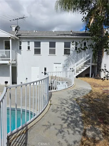 View of home from patio area directly above pool