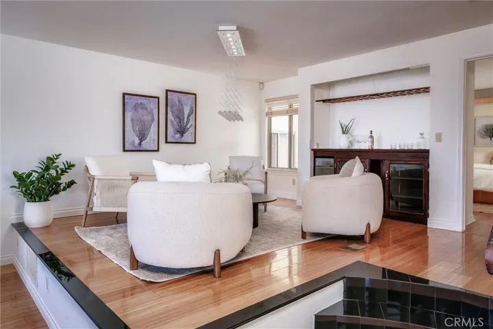 Elevated second living room area with wine bar.