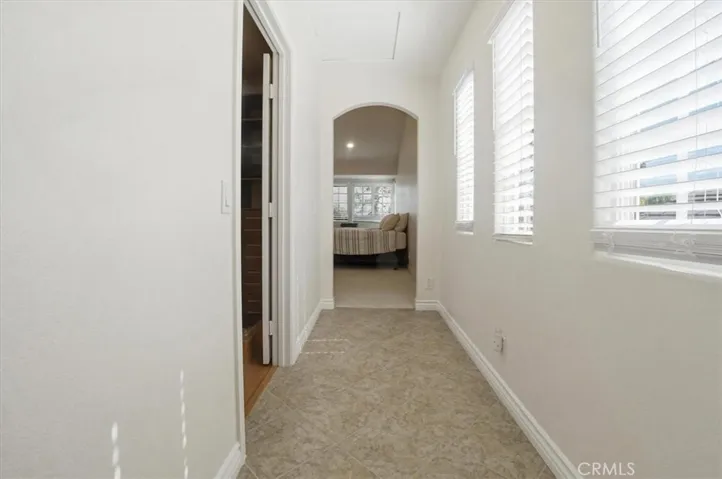 Primary bedroom walkway to closet and bathroom area