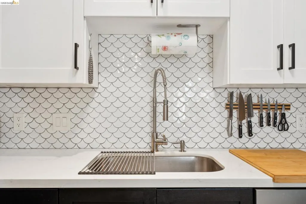 Kitchen with white upper cabinetry and dark lower cabinetry