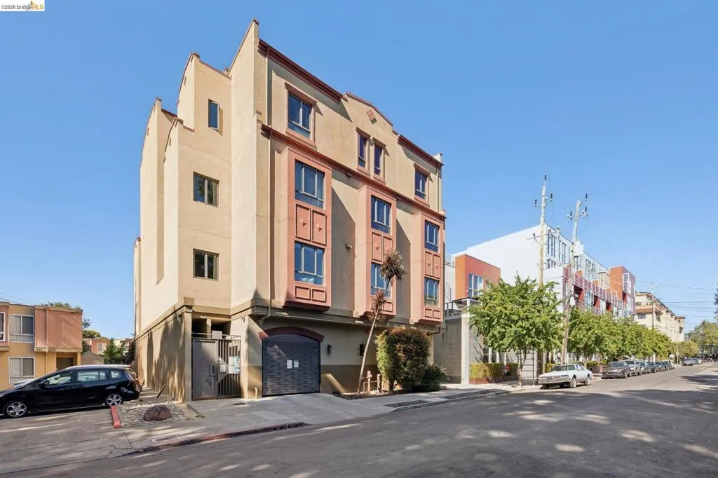 Multi-story stucco exterior with decorative cornices and framed windows