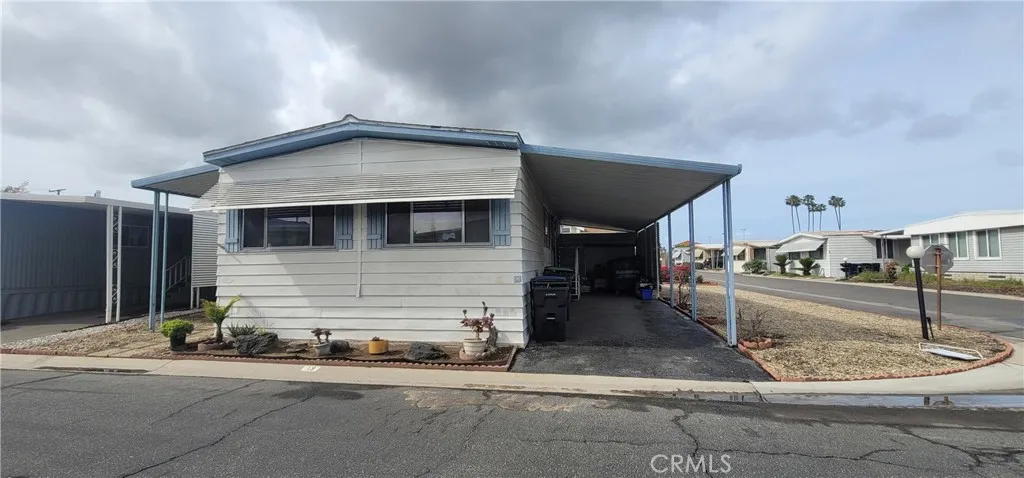 front side and carport with view of lot