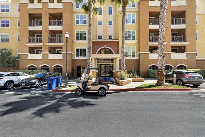 Multi-story stucco exterior with arched entryways and multiple balconies