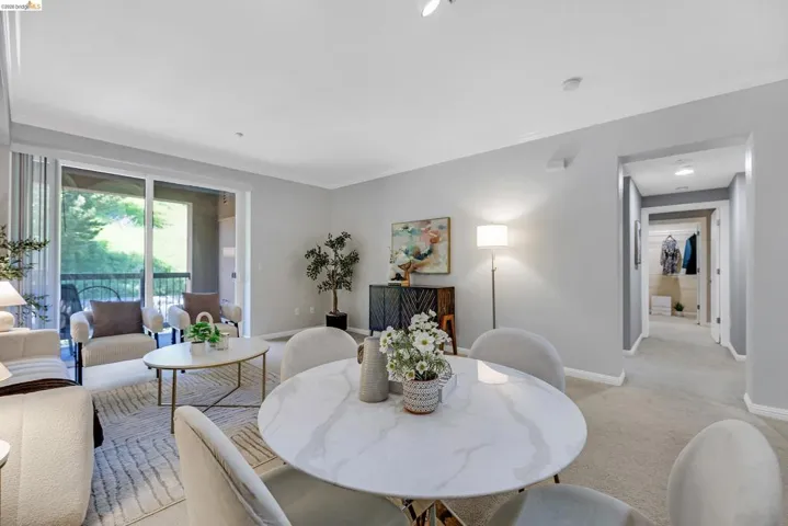 Open-concept living space featuring light gray wall paint, crown molding, and recessed lighting