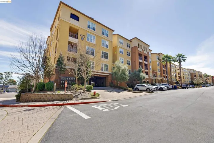 Multi-story residential building featuring a stucco exterior and multiple balconies