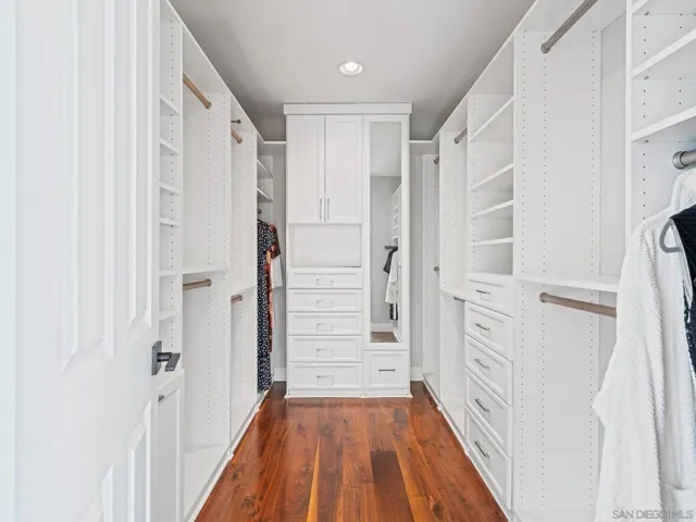 Spacious walk in closet with custom built ins