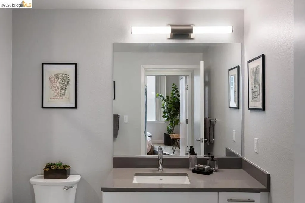 Bathroom featuring a textured wall and vanity