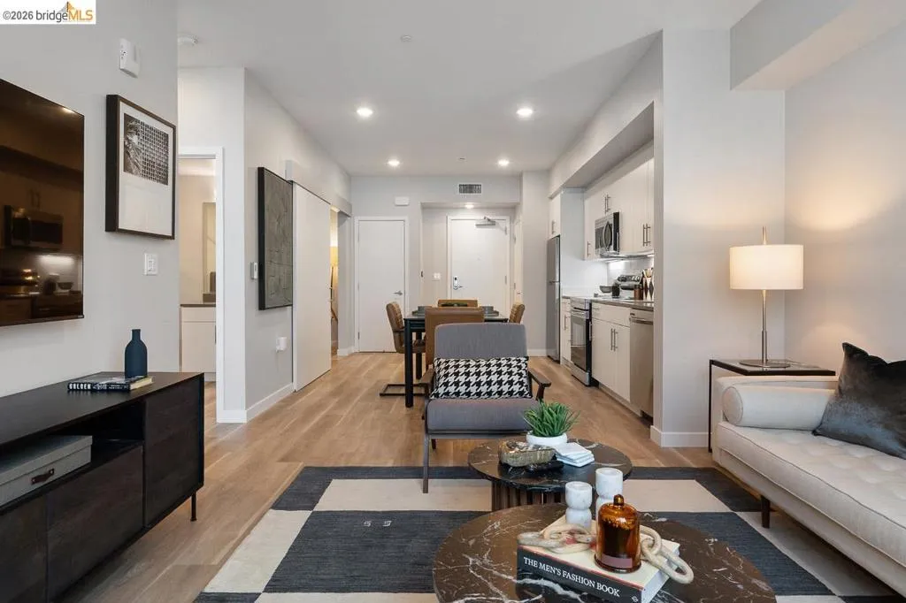Living area with light wood-style floors and recessed lighting