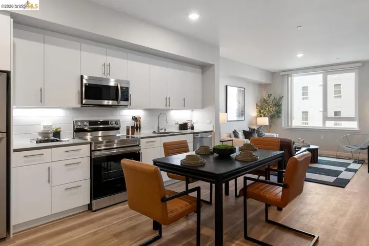 Kitchen featuring stainless steel appliances, white cabinets, tasteful backsplash, light wood-style floors, and recessed lighting