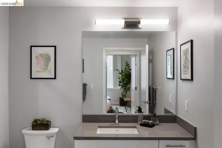 Bathroom featuring a textured wall and vanity