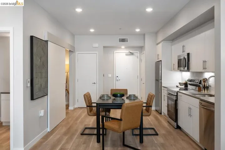 Kitchen featuring white cabinetry, stainless steel appliances, light wood-style floors, recessed lighting, and modern cabinets