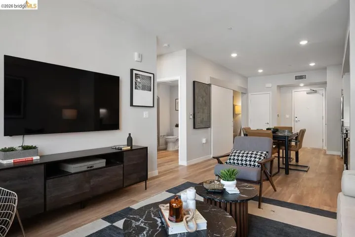 Living room featuring light wood-type flooring and recessed lighting