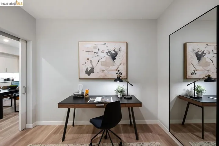 Office space with light wood-style floors and baseboards