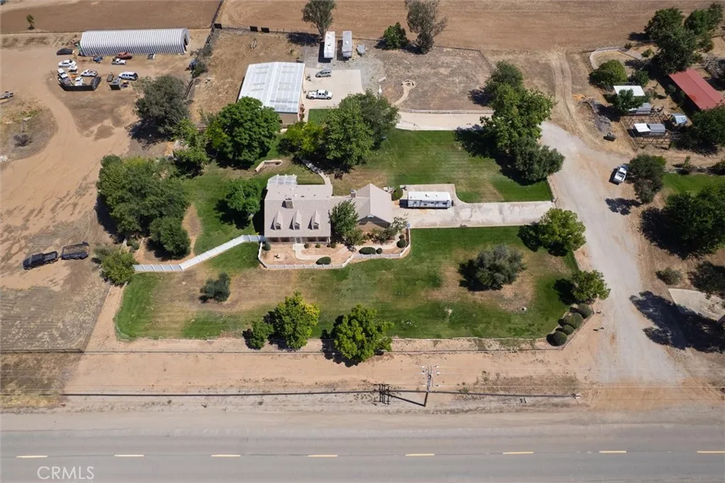 Aerial View of Property:  Main house, Attached Garage, Stel Workshop & ADU; and beautiful green grounds.